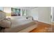 Bedroom with hardwood flooring, neutral walls, trim, furnishings, and painting on wall at 630 4Th Nw Ave, Hickory, NC 28601