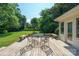 A spacious deck features an outdoor dining set, offering a relaxing space with views of the backyard at 630 4Th Nw Ave, Hickory, NC 28601