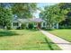 Inviting single-Gathering home with manicured lawn, mature trees, and a welcoming red front door at 630 4Th Nw Ave, Hickory, NC 28601
