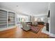 Spacious living room with hardwood floors, fireplace, and built-in bookshelves, adjacent to the sunroom at 630 4Th Nw Ave, Hickory, NC 28601