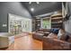 Inviting living room adjacent to dining area with a comfortable leather sectional and hardwood flooring at 630 4Th Nw Ave, Hickory, NC 28601