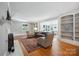 Bright living room with hardwood floors, fireplace, built-in bookshelves, and access to the sunroom at 630 4Th Nw Ave, Hickory, NC 28601