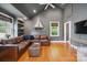 Comfortable living room with vaulted ceilings, hardwood floors, and a cozy leather sectional at 630 4Th Nw Ave, Hickory, NC 28601