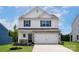 Charming two-story home with stone accents, attached garage, and lush green lawn at 7007 Jerimoth Dr, Charlotte, NC 28215