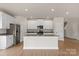 Kitchen featuring a large central island with granite counters and stainless appliances at 7007 Jerimoth Dr, Charlotte, NC 28215
