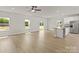 Expansive living area with hardwood floors, a granite island, and access to the backyard at 7007 Jerimoth Dr, Charlotte, NC 28215