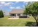 Aerial view of a home featuring a screened-in porch, stone patio, and well-manicured backyard at 7015 Gracefield Ln, Fort Mill, SC 29707