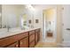 Bathroom with double vanity sinks, tile floors, and neutral decor at 7015 Gracefield Ln, Fort Mill, SC 29707