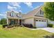 Inviting brick and siding home with manicured landscaping and a two-car garage, offering a welcoming curb appeal at 7015 Gracefield Ln, Fort Mill, SC 29707