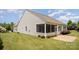 Beautiful home exterior with a screened porch, stone patio, and lush green lawn at 7015 Gracefield Ln, Fort Mill, SC 29707