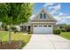 Charming brick home featuring a well-maintained lawn and a two-car garage, providing comfortable suburban living at 7015 Gracefield Ln, Fort Mill, SC 29707