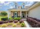 Charming front porch with decorative columns and lush landscaping creates an inviting entrance to this home at 7015 Gracefield Ln, Fort Mill, SC 29707