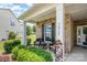 Cozy front porch with seating, showcasing the brick facade and manicured greenery, perfect for relaxing at 7015 Gracefield Ln, Fort Mill, SC 29707