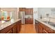 This spacious kitchen features granite countertops, stainless steel appliances, and wooden flooring at 7015 Gracefield Ln, Fort Mill, SC 29707