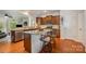 Spacious kitchen featuring a large island with seating, stainless steel appliances, and hardwood floors, great for cooking at 7015 Gracefield Ln, Fort Mill, SC 29707