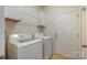 Clean laundry room equipped with washer, dryer, and storage cabinets at 7015 Gracefield Ln, Fort Mill, SC 29707