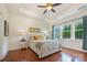 Relaxing main bedroom with a tray ceiling, hardwood floors, and natural light at 7015 Gracefield Ln, Fort Mill, SC 29707