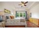 Comfortable main bedroom with hardwood floors, tray ceiling, and bright windows at 7015 Gracefield Ln, Fort Mill, SC 29707