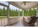 Inviting screened-in porch with comfortable seating and serene views of the lush backyard at 7015 Gracefield Ln, Fort Mill, SC 29707