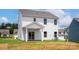 The rear of this two-story home features a covered patio and a spacious backyard at 7023 Jerimoth Dr, Charlotte, NC 28215