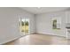 Hardwood floors are featured in this living space with a sliding glass door to the backyard at 7023 Jerimoth Dr, Charlotte, NC 28215