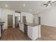 Open-concept kitchen with an island featuring granite countertops, stainless steel appliances, and hardwood floors at 7315 Jerimoth Dr, Charlotte, NC 28215