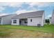 A spacious backyard features a covered patio, and lush green grass, perfect for outdoor activities at 7319 Jerimoth Dr, Charlotte, NC 28215