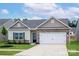Charming single-story home with stone accents, a two-car garage, and a well-maintained lawn at 7319 Jerimoth Dr, Charlotte, NC 28215