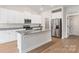Modern kitchen boasts stainless steel appliances, an island with granite countertop, and custom cabinets at 7319 Jerimoth Dr, Charlotte, NC 28215