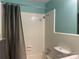 Tiled bathroom with a shower-tub combination and a gray shower curtain at 1320 Kings Cir, Shelby, NC 28150