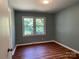 Cozy bedroom with wood-look flooring and a bright window offering a pleasant view at 1320 Kings Cir, Shelby, NC 28150