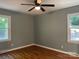 Well-lit bedroom with ceiling fan and ample natural light from the bright windows at 1320 Kings Cir, Shelby, NC 28150