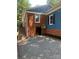 Exterior of home featuring brick foundation, stone pavers, and a secure side entry at 1320 Kings Cir, Shelby, NC 28150