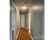 Clean hallway with wood-look floors connecting various rooms in the house at 1320 Kings Cir, Shelby, NC 28150