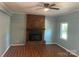 Inviting living room with a brick fireplace and wood-look flooring, perfect for cozy evenings at 1320 Kings Cir, Shelby, NC 28150