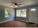 Bright living room featuring large windows that fill the space with natural light and wood-look flooring at 1320 Kings Cir, Shelby, NC 28150