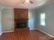 Cozy living room with a classic brick fireplace and mantle at 1320 Kings Cir, Shelby, NC 28150