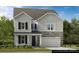 Charming two-story home features a stone facade, vertical siding, and an attached two-car garage at 143 Goorawing Ln, Mooresville, NC 28115