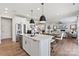 Modern kitchen with white cabinets, stainless steel appliances, and an island with pendant lighting at 143 Goorawing Ln, Mooresville, NC 28115