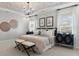 Bedroom features decorative ceiling, chandelier, large bed, and bedside tables with lamps at 143 Goorawing Ln, Mooresville, NC 28115