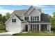 Charming two-story home featuring a two-car garage and a covered front porch at 150 Nicholson Ln, Mooresville, NC 28115