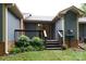 A split level wood back deck with stairs has nice plantings and convenient access to the yard at 238 Pointe Cir, Rock Hill, SC 29732
