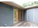 A gray wood back deck features a sliding glass door to the house and storage at 238 Pointe Cir, Rock Hill, SC 29732