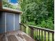 A cozy back deck with wooden railing overlooks a lush green yard and mature trees at 238 Pointe Cir, Rock Hill, SC 29732