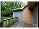 Outdoor deck with wooden railing, siding, and brickwork surrounded by greenery at 238 Pointe Cir, Rock Hill, SC 29732