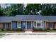 Charming single-story home with blue siding, black shutters, and a well-manicured front yard at 238 Pointe Cir, Rock Hill, SC 29732