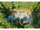 Aerial view of estate showcasing the home's spacious lot, mature trees, and sparkling pool at 4552 Sawgrass Ct, Denver, NC 28037