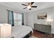 Cozy bedroom with a ceiling fan, dresser, and stylish decor elements at 4552 Sawgrass Ct, Denver, NC 28037