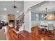 Open entryway featuring hardwood floors, staircase, stone fireplace, and adjacent dining room at 4552 Sawgrass Ct, Denver, NC 28037