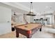 Game room with a pool table and lots of space for entertaining, open to the kitchen at 4552 Sawgrass Ct, Denver, NC 28037